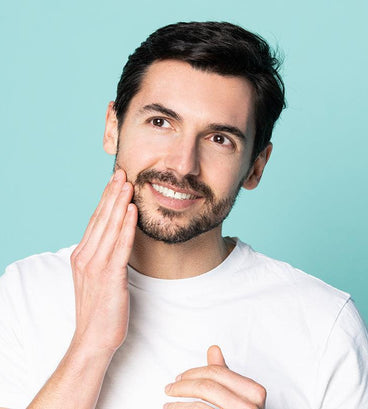 Man applying beard growth stimulating serum