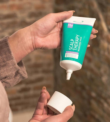 Woman holding neofollics scalp therapy nourishing mask