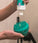 Woman applying scalp shampoo on Neofollics scalp massaging shampoo brush