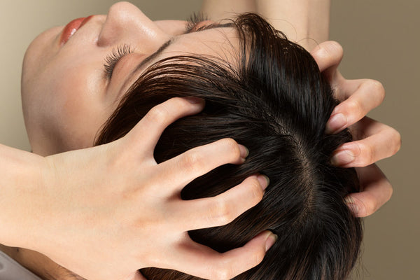 Woman massaging her scalp