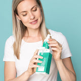 Woman unpacking Neofollics hair growth stimulating lotion
