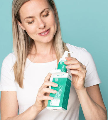 Woman unpacking hair growth stimulating shampoo