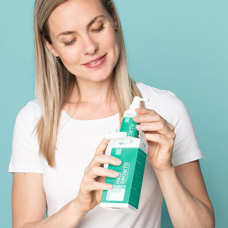 Woman unpacking hair growth stimulating shampoo