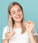 Woman holding Neofollics hair growth supporting tablet and glass of water