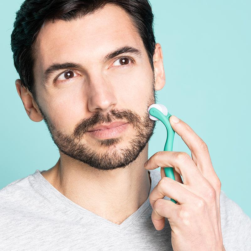 Man rolling Neofollics beard growth roller on cheek