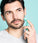 Man rolling neofollics beard growth roller on cheek