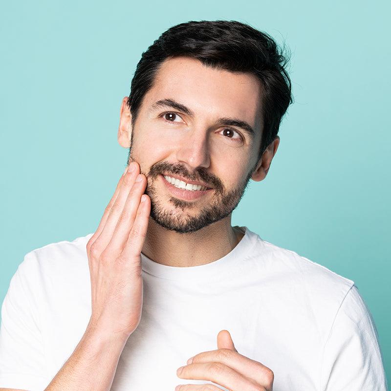 Man applying neofollics beard growth stimulating serum