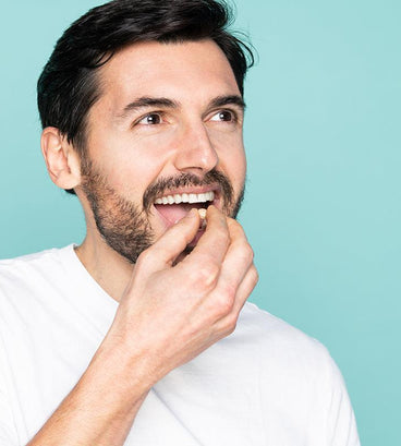 Man taking a neofollics beard growth supporting tablet
