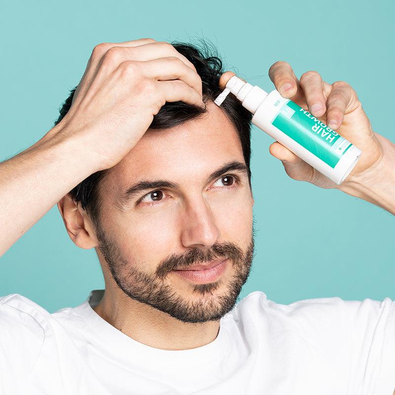 Man applying Neofollics hair growth stimulating lotion on head