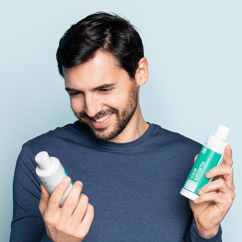 Man holding Neofollics hair growth stimulating conditioner