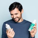 Man holding Neofollics hair growth stimulating shampoo